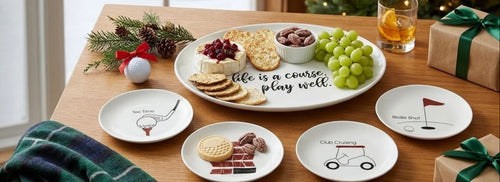 Life Is a Course golf platter and golf appetizer plates on a holiday table by a snowy window